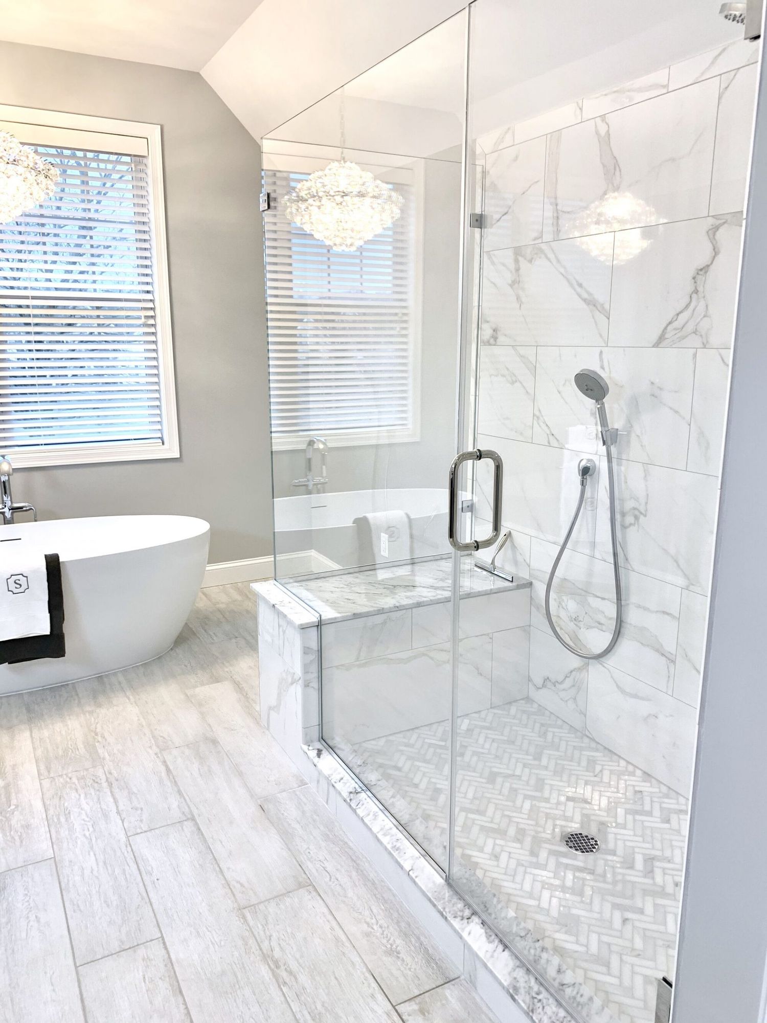 Marble bathroom with freestanding tub and frameless glass shower