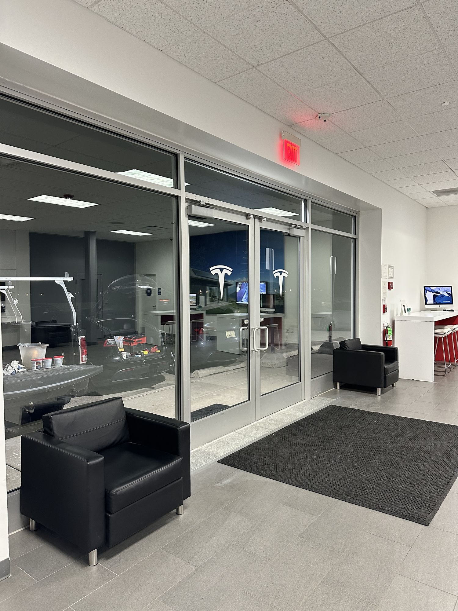 Finished commercial showroom entrance with glass storefront and tiled floor