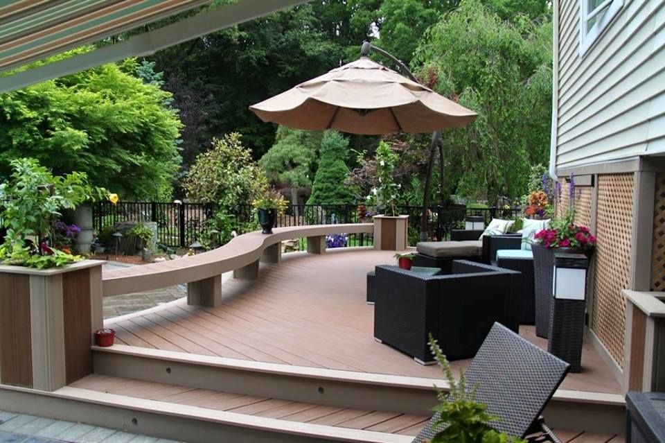 Curved composite deck with built-in bench seating and garden