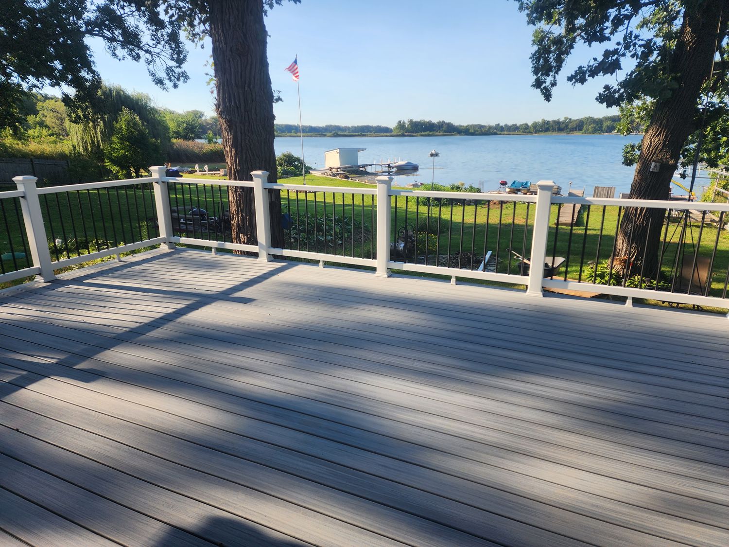Composite deck overlooking a lake with white and black railings
