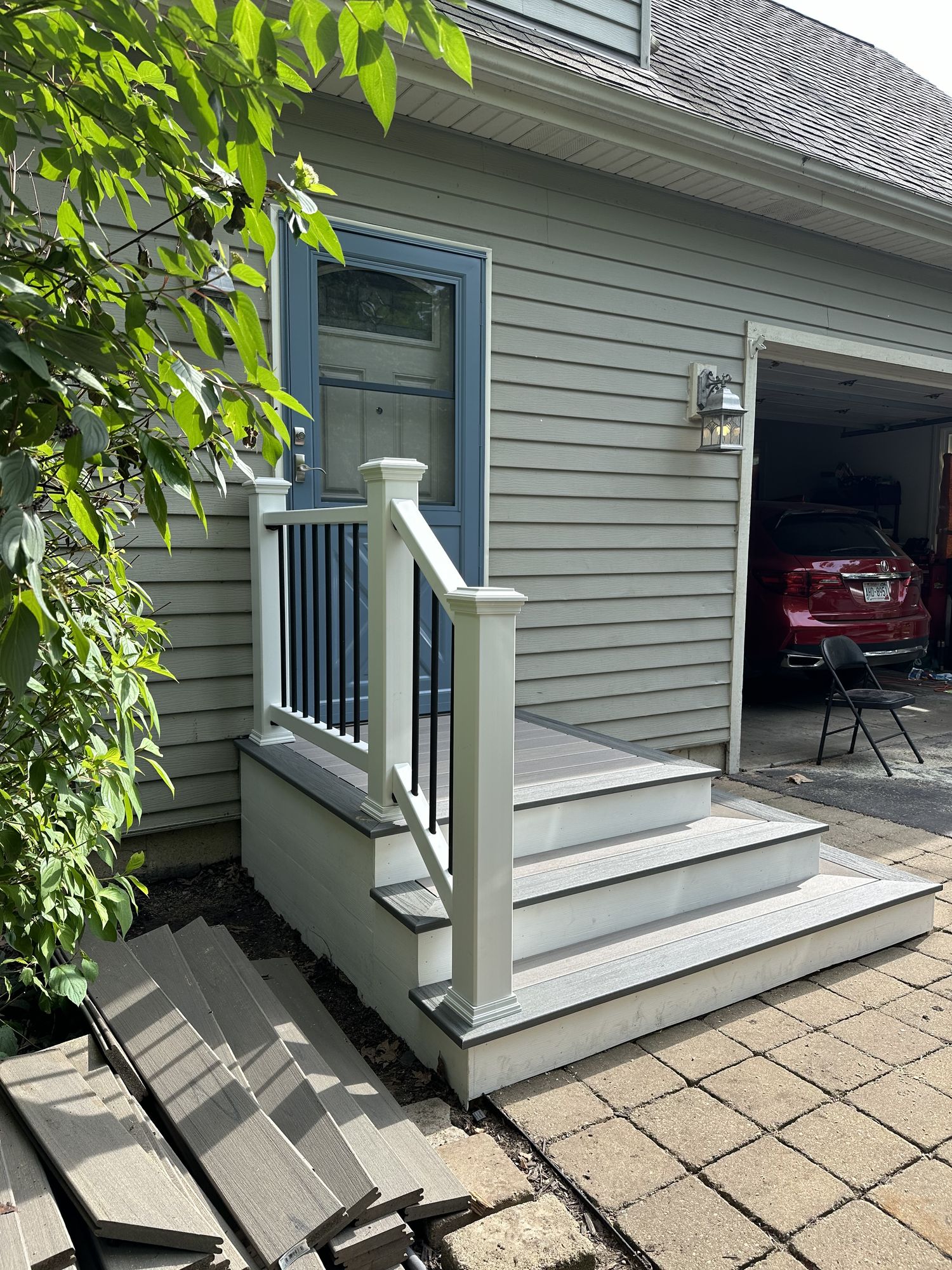 New composite front entry steps with white railings, finished