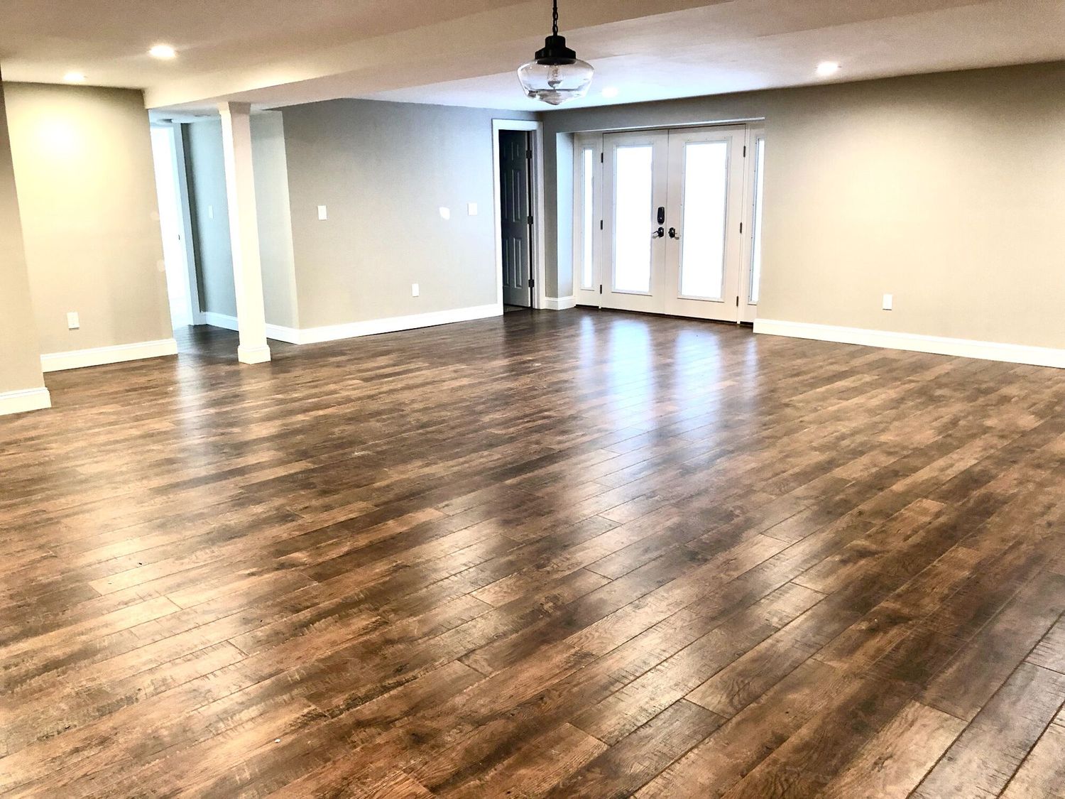 Freshly refinished hardwood floors in an open plan room