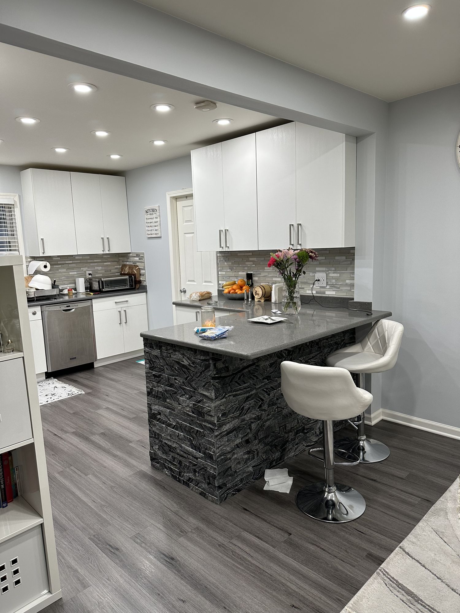 Kitchen remodel with a stacked stone breakfast island and bar stools