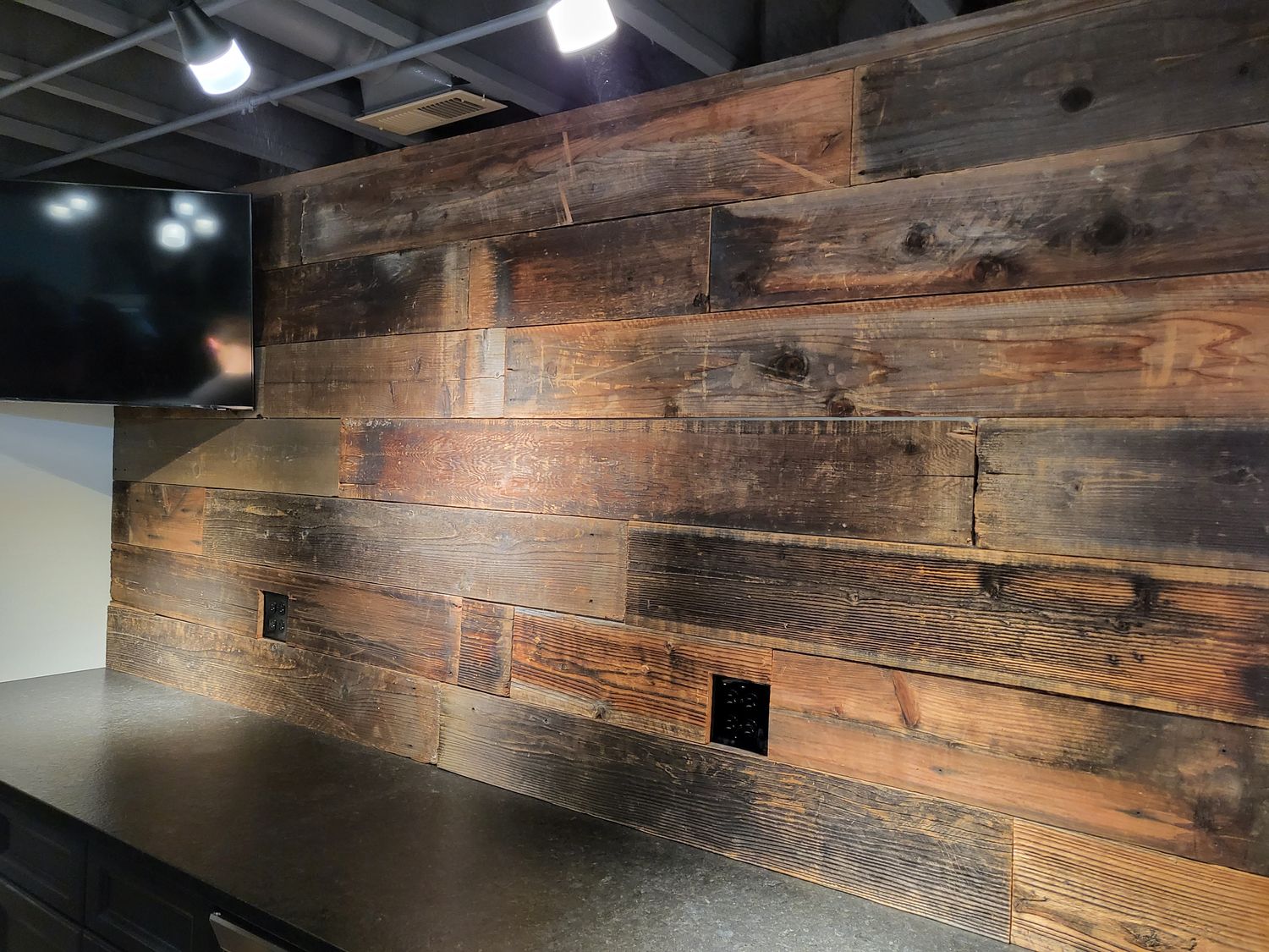 Feature wall clad in reclaimed barn wood boards