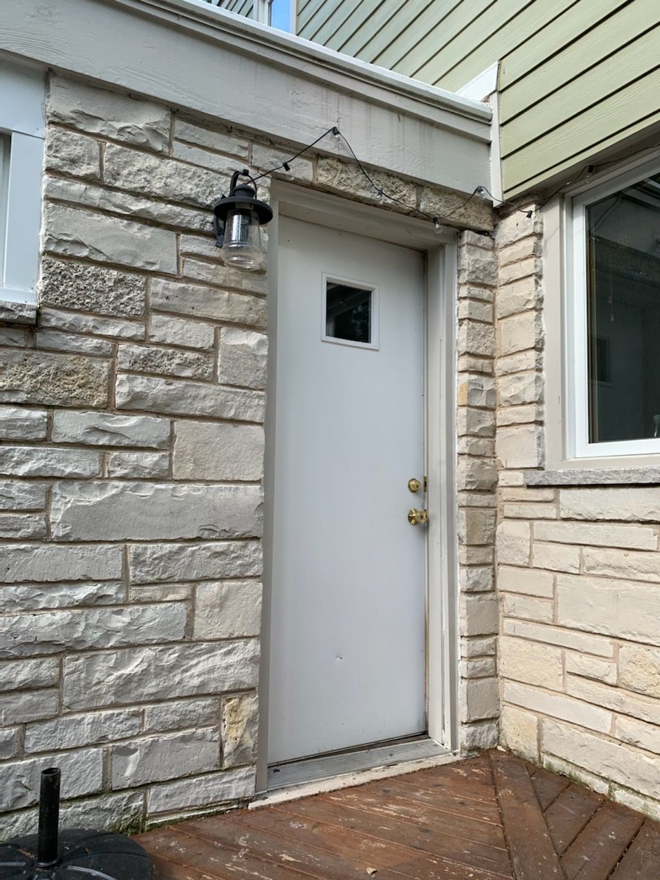 Exterior stone veneer around a new service entry door